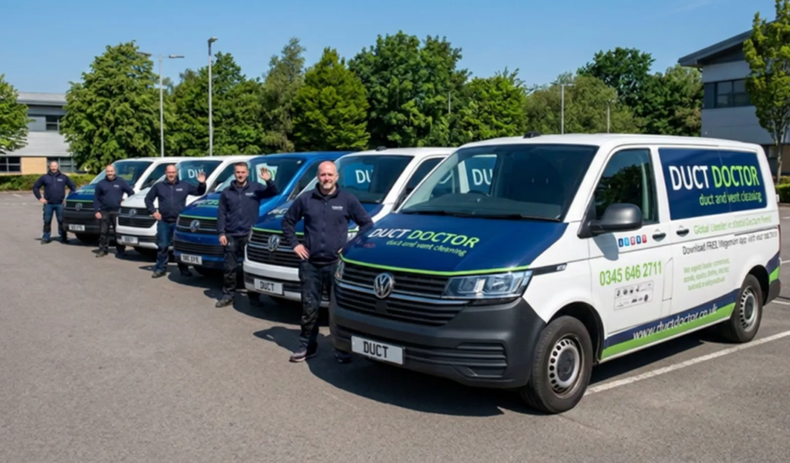 The Duct Doctor team standing beside their branded vans